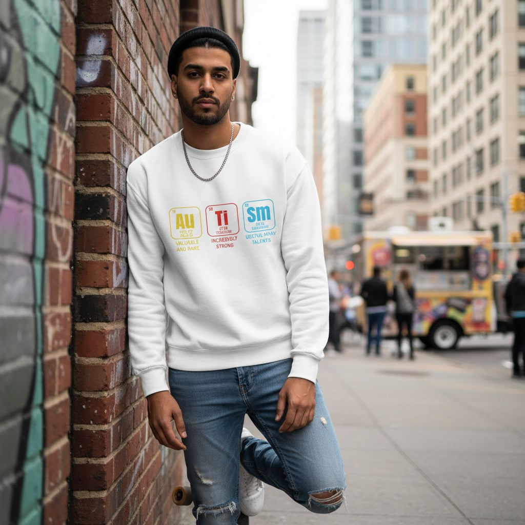 South Asian man wearing a white autism periodic table sweatshirt.