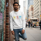 South Asian man wearing a white autism periodic table sweatshirt.
