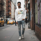 South Asian man wearing a white "Be Kind" butterfly ASL autism awareness sweatshirt.