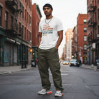 South Asian man wearing a white autism awareness t-shirt.