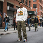 South Asian man wearing a white "It's Okay to be Different" autism awareness giraffe sweatshirt.