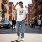 South Asian man wearing a white It is Okay to be Different autism awareness t-shirt with an elephant and unicorn design.
