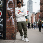 South Asian man wearing a white Love Needs No Words autism awareness sweatshirt.
