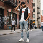 South Asian man wearing a white Love Needs No Words autism awareness T-shirt.