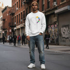 South Asian man wearing a white autism awareness puzzle heart sweatshirt.
