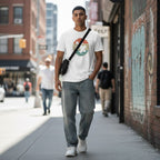South Asian man wearing a white retro sunset puzzle piece autism awareness t-shirt.