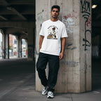 South Asian man wearing a white streetwear t-shirt in an urban setting