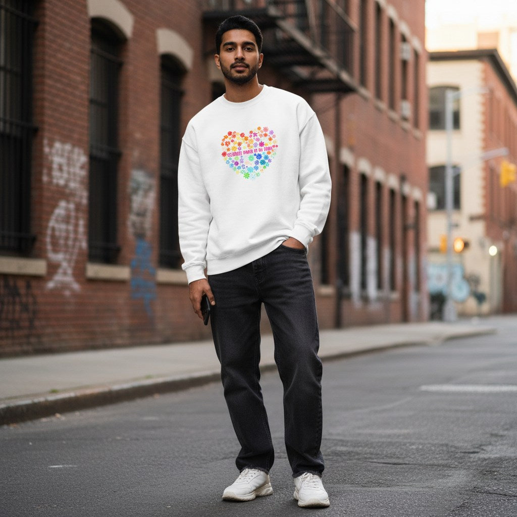 South Asian man wearing a white celebrate minds floral heart sweatshirt.
