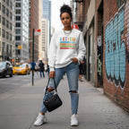 South Asian woman wearing a white autism awareness sweatshirt.