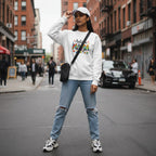 South Asian woman wearing a white autism mama sweatshirt.