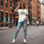 South Asian woman wearing a white autism mama t-shirt.