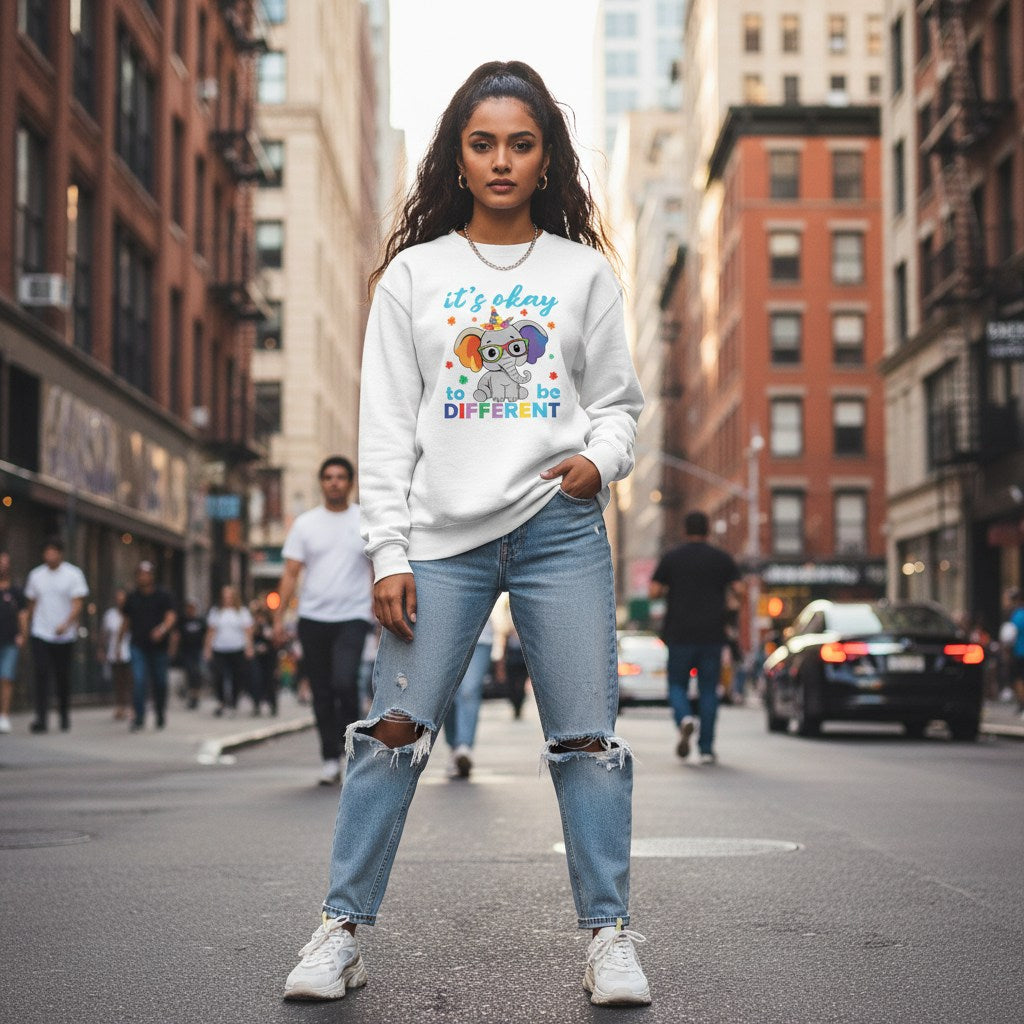 South Asian woman wearing a white its okay to be different autism awareness elephant sweatshirt.