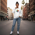 South Asian woman wearing a white puzzle heart logo autism awareness sweatshirt.
