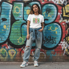 South Asian woman wearing a white autism awareness t-shirt in a streetwear style.