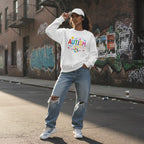 South Asian woman wearing a white autism awareness sweatshirt in a streetwear style.