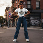 South Asian woman in urban streetwear standing against a vibrant graffiti wall