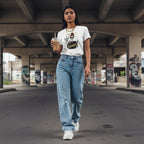 South Asian woman wearing a white streetwear t-shirt outdoors.