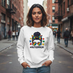 South Asian woman wearing a white Autism Mom sweatshirt.