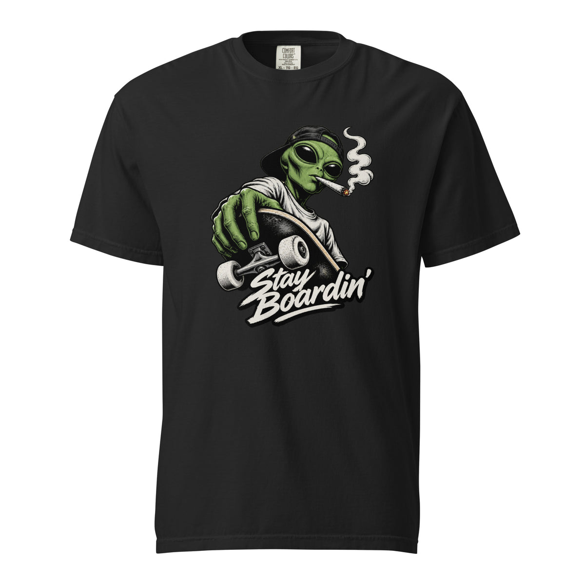 Black T-Shirt featuring a green alien in a backwards cap riding a skateboard and smoking above “Stay Boardin’” lettering.