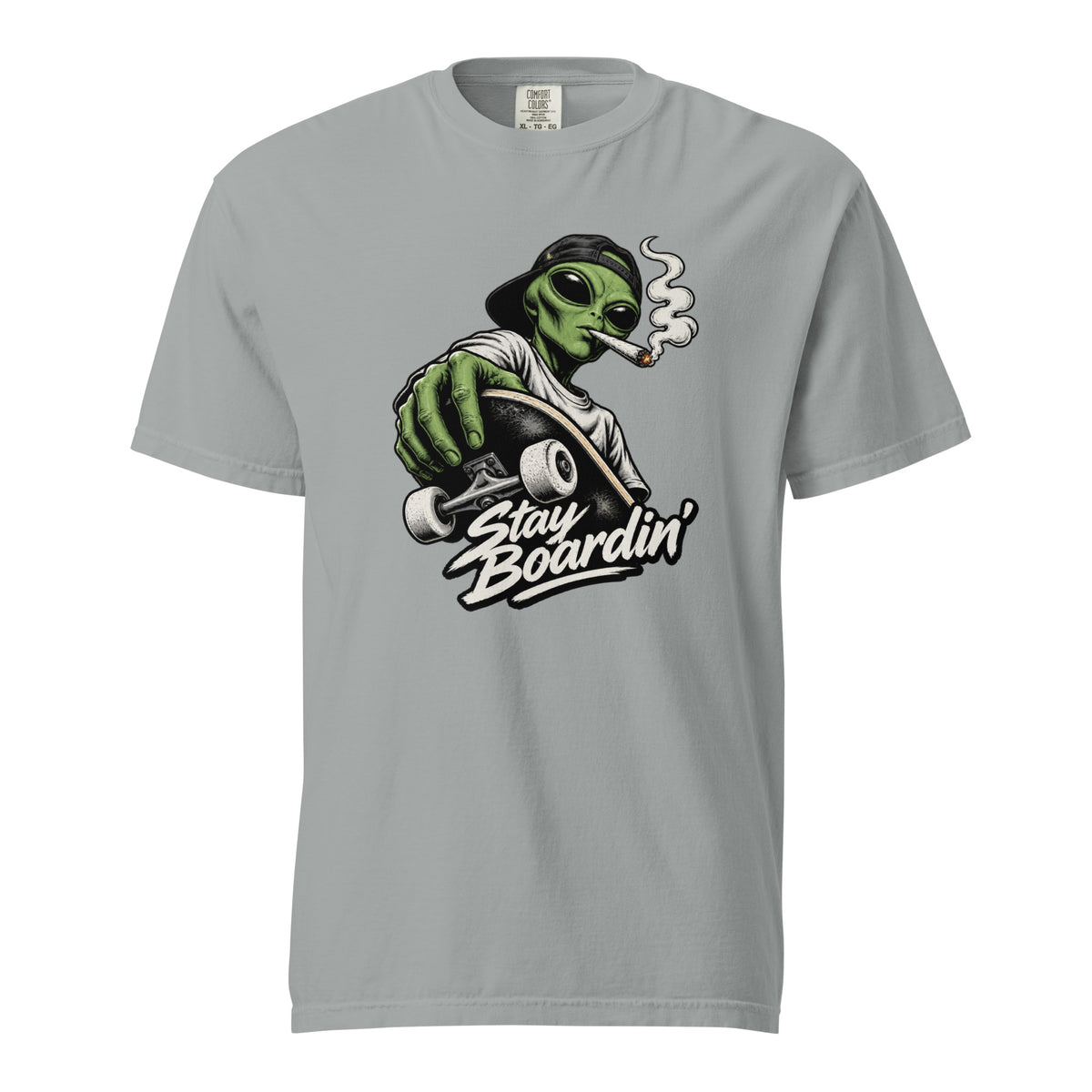 Granite T-shirt featuring a green alien in a backwards cap riding a skateboard while smoking, above “Stay Boardin’” lettering.