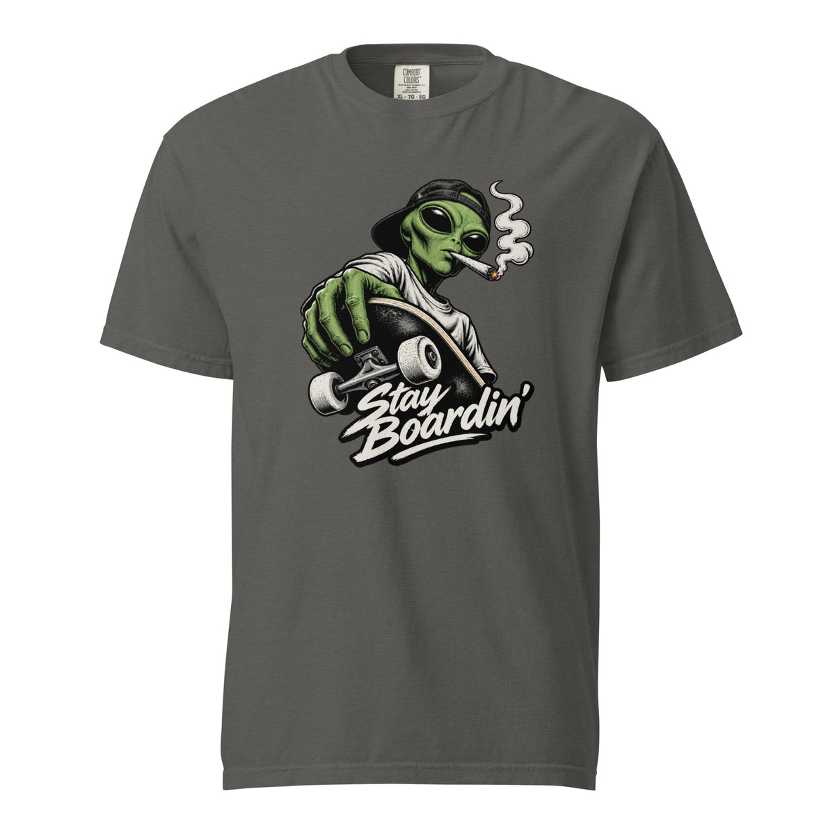Front of Pepper T-Shirt featuring a green alien in a backwards cap riding a skateboard and smoking above “Stay Boardin’” lettering.