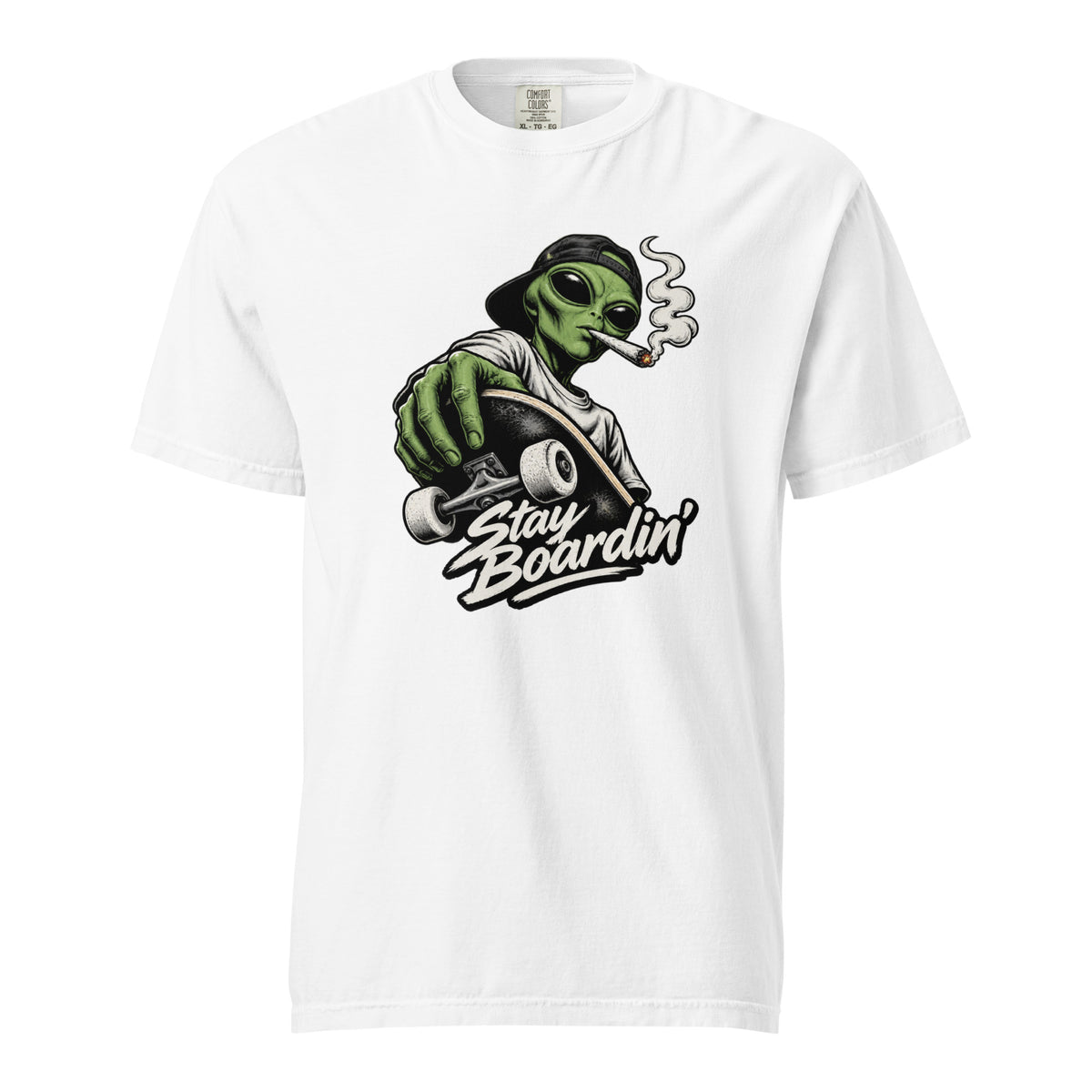 White T-Shirt with a green alien in a backwards cap riding a skateboard while smoking, above bold “Stay Boardin’” lettering.