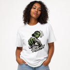 Model wearing a White T-Shirt featuring a green alien with a backwards cap riding a skateboard, smoking above “Stay Boardin’” lettering.