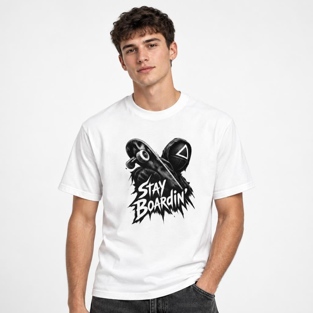Front view of a white T-shirt with a black-and-white skateboard and helmet graphic and “STAY BOARDIN” text.