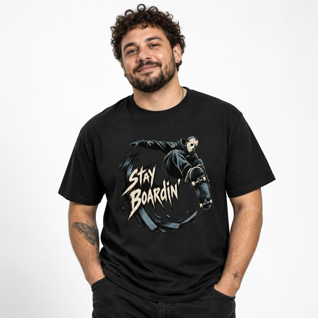 Model wearing a black T-shirt with a masked skateboarder airborne above a skateboard and jagged “STAY BOARDIN” lettering.