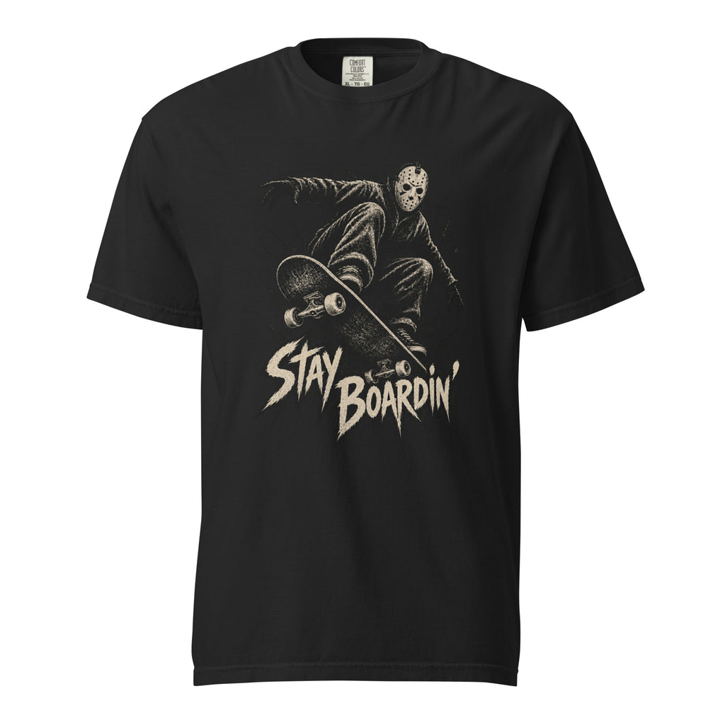 Front view of a black T-shirt featuring a masked skater crouching on a skateboard above distressed cream “STAY BOARDIN’” lettering.