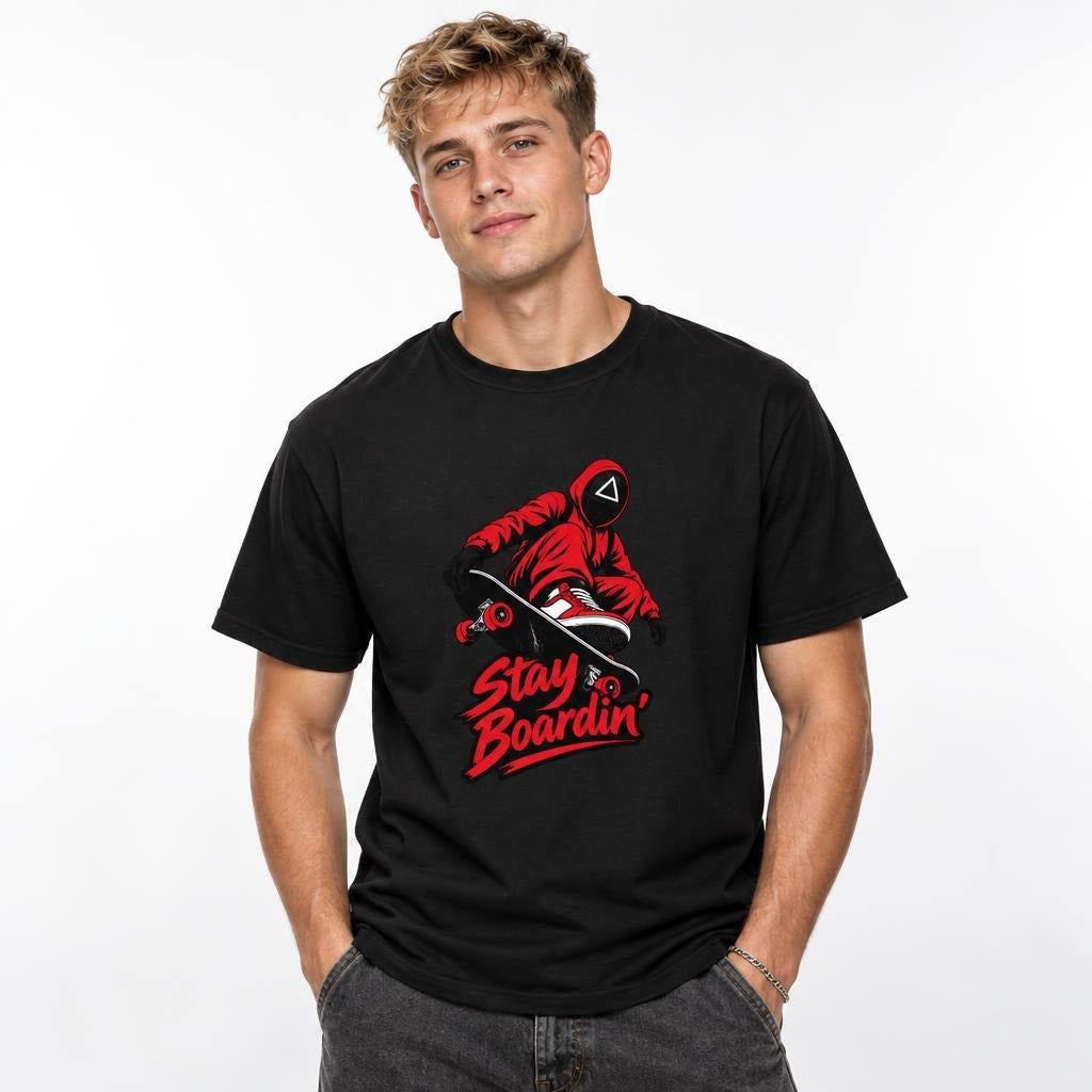 Front view of a Black T-shirt featuring a masked skateboarder riding a skateboard above bold red “Stay Boardin’” lettering.