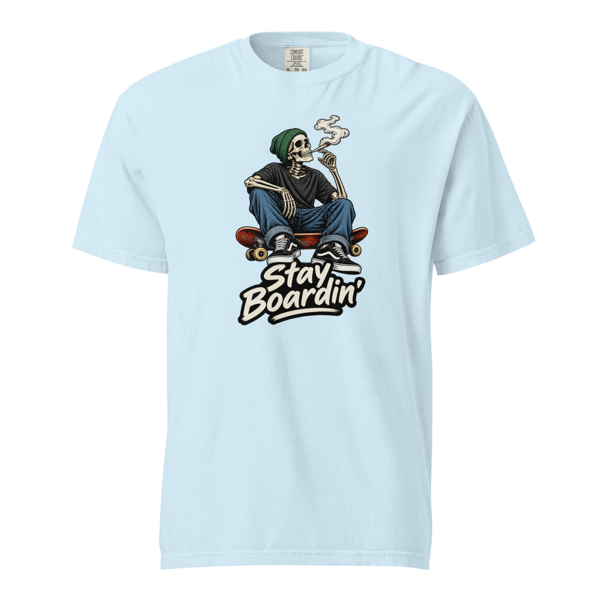 Front view of a Chambray T-shirt with a seated smoking skeleton in a green beanie on a skateboard above “Stay Boardin’” lettering.