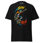 Stay Real graphic showing a skateboarding skeleton with colorful blue, yellow, orange, and red accents on a Black T-shirt.