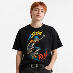 Stay Real Skeleton Skater Skeleton Skateboard t shirt in Black worn by a studio model in an upper-body front relaxed pose on a clean white background