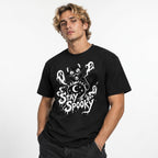 Model wearing a black T-shirt with a mischievous cat behind a crystal ball, three ghosts, stars, a crescent moon, and Stay Spooky lettering.