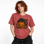 Front view of a Crimson T-Shirt featuring a black cat with bright orange eyes draped over a grinning orange pumpkin and Stay Spooky lettering.