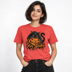 Model wearing a Paprika T-shirt featuring a black cat with bright orange eyes over a grinning orange jack-o’-lantern and “Stay Spooky” lettering.