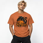 Front view of a Yam T-shirt worn by a model, featuring a black cat draped over a grinning orange pumpkin with Stay Spooky lettering.