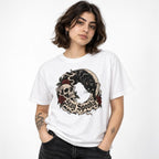 Front view of a white T-shirt on a model featuring Stay Spooky lettering, a black cat, skull, crescent moon, and red roses.