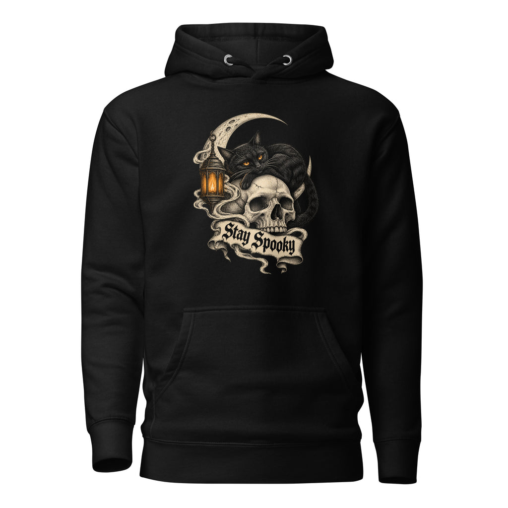 Front view of a black hoodie featuring a black cat with amber eyes reclining over a skull, crescent moon, lantern, and “Stay Spooky” banner.