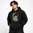 Black hoodie featuring a black cat with amber eyes over a skull, framed by a crescent moon and lantern, with “Stay Spooky” text.