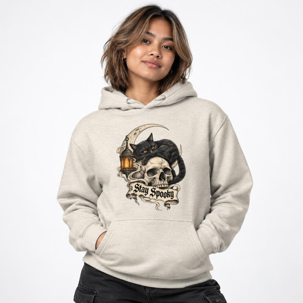 Front view of an Oatmeal Heather hoodie featuring a black cat with amber eyes reclining over a skull beneath a crescent moon.