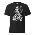 Front of a black T-shirt featuring a hooded ghost, skeletal hands, a candle lantern, and dripping “Stay Spooky” lettering.