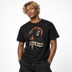 Model wearing a black T-shirt featuring a hooded grim reaper skeleton holding a lantern before a red moon with a Stay Spooky banner.