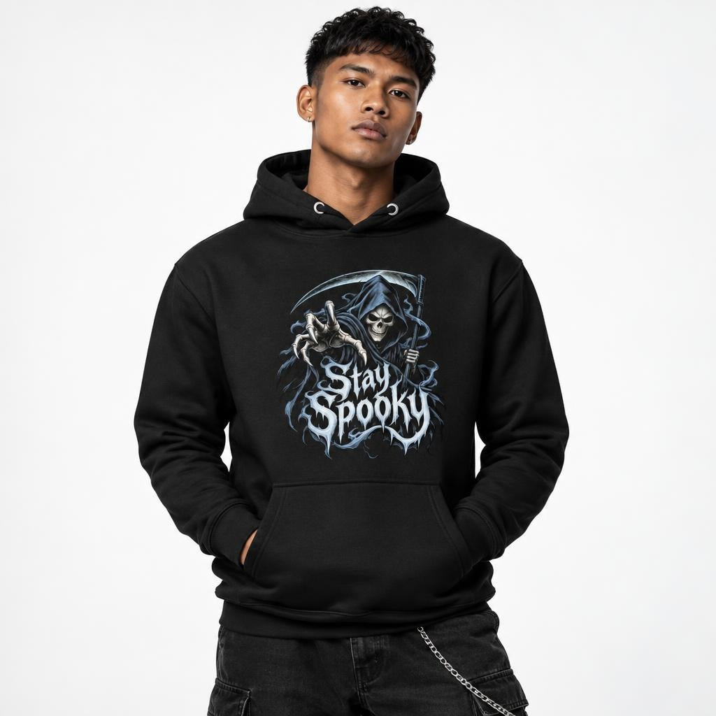 Model wearing a black hoodie with front artwork of a grim reaper, skull and crescent moon above Stay Spooky lettering.