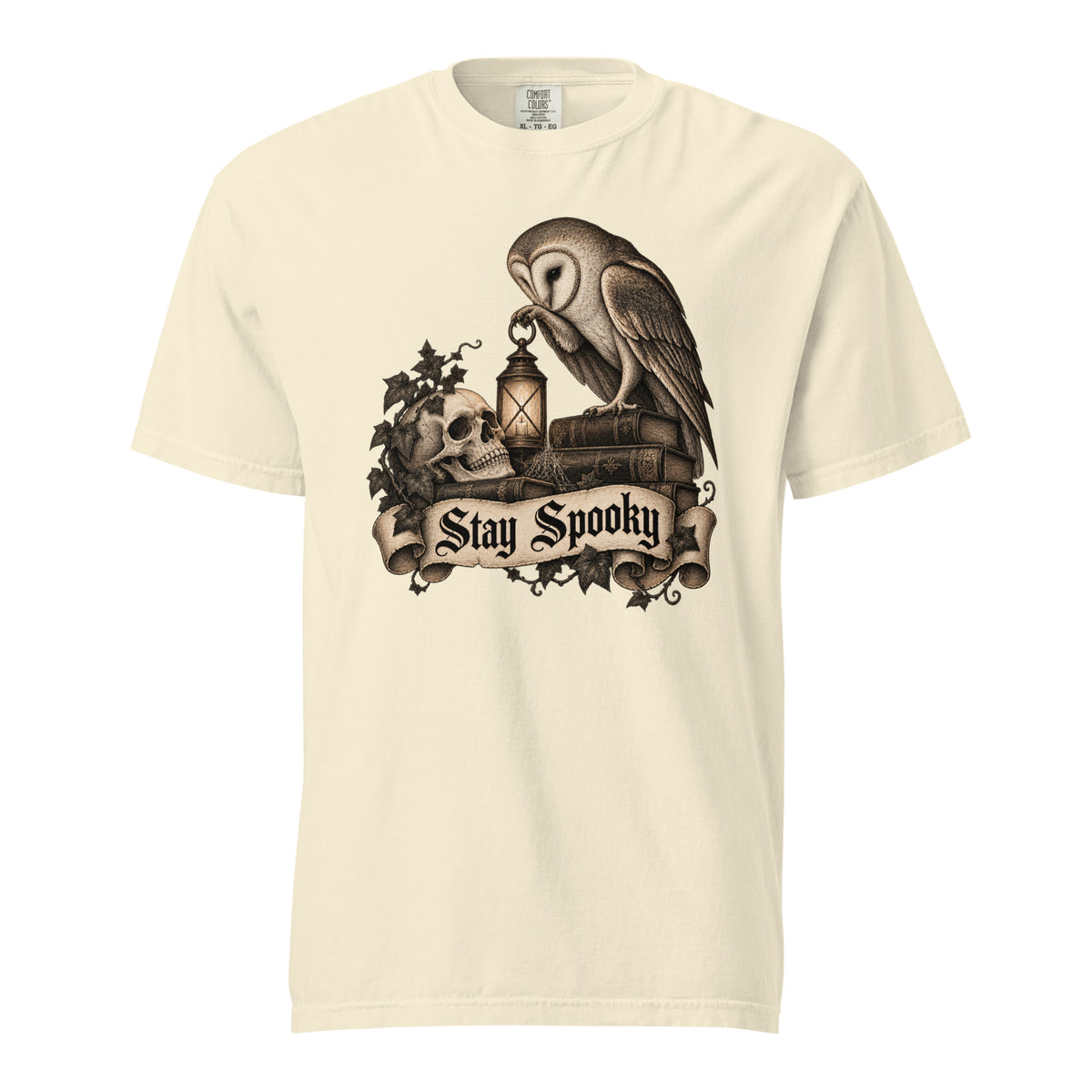 Ivory T-shirt featuring a vintage gothic illustration of an owl, skull, and lantern with a “Stay Spooky” banner.