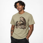 Front view of a khaki T-shirt on a model, featuring “Stay Spooky” with an owl, skull, lantern, books and ivy in a vintage gothic illustration.