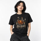 Front view of a Black T-shirt with a grinning pumpkin, skeleton ghosts, candles, and distressed STAY SPOOKY lettering.