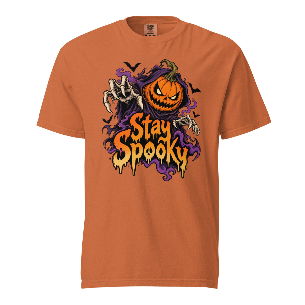 Yam t shirt featuring A front chest graphic reads “Stay Spooky” in large dripping orange and cream lettering. Above it is an angry orange jack-o’-lantern framed by purple smoky shapes, with reaching skeletal hands and se