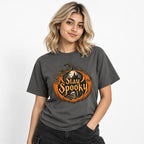 Front view of a model wearing a Pepper T-shirt with a pumpkin, skull, haunted castle, bats and “Stay Spooky” artwork.